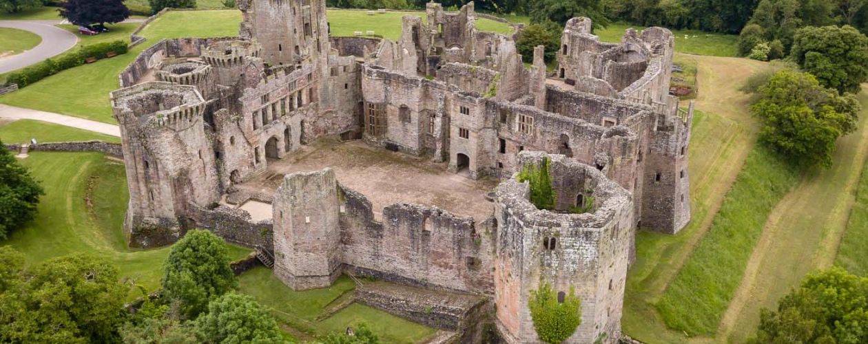 Aerial view of the ruins of a large medieval castle (Raglan Cast
