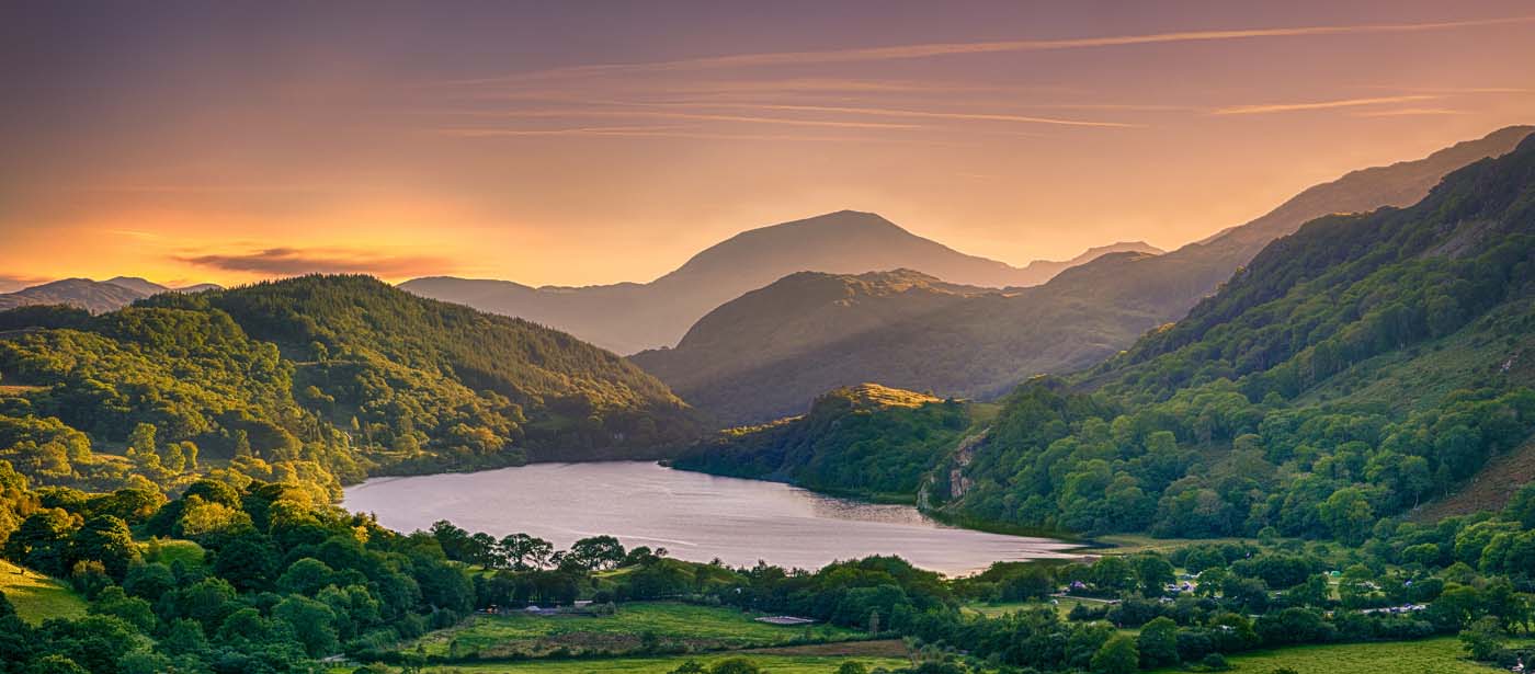 The Sun shining through a mountain pass over Llyn Gwynant, Snowd